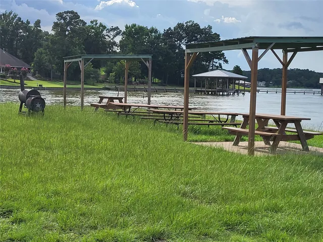 a view of a swimming pool with a bench and lawn chairs
