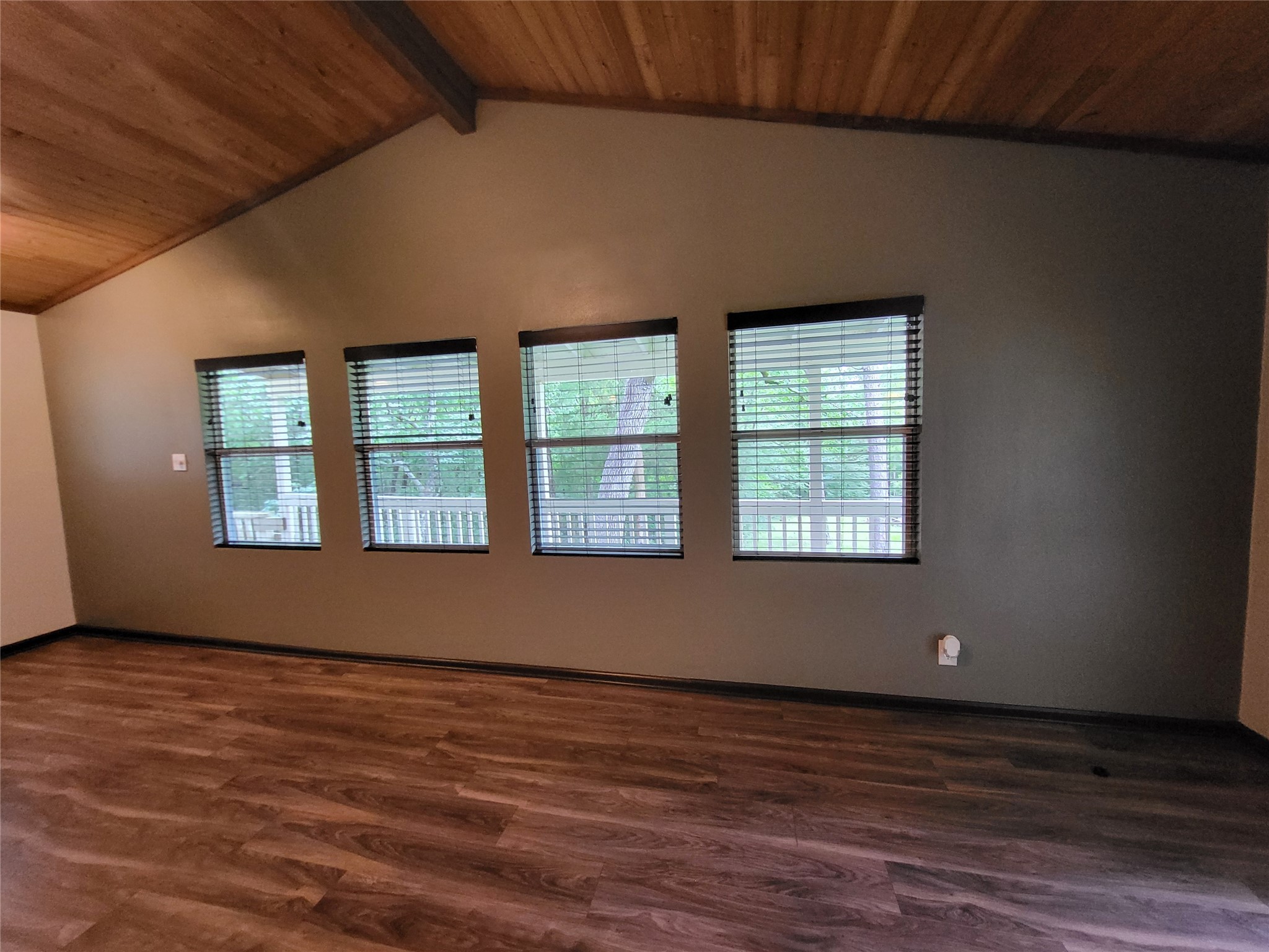 30 Ridge Creek Drive Coldspring, TX 77331 - Photo 5 of 38 a view of an empty room with wooden floor and a window