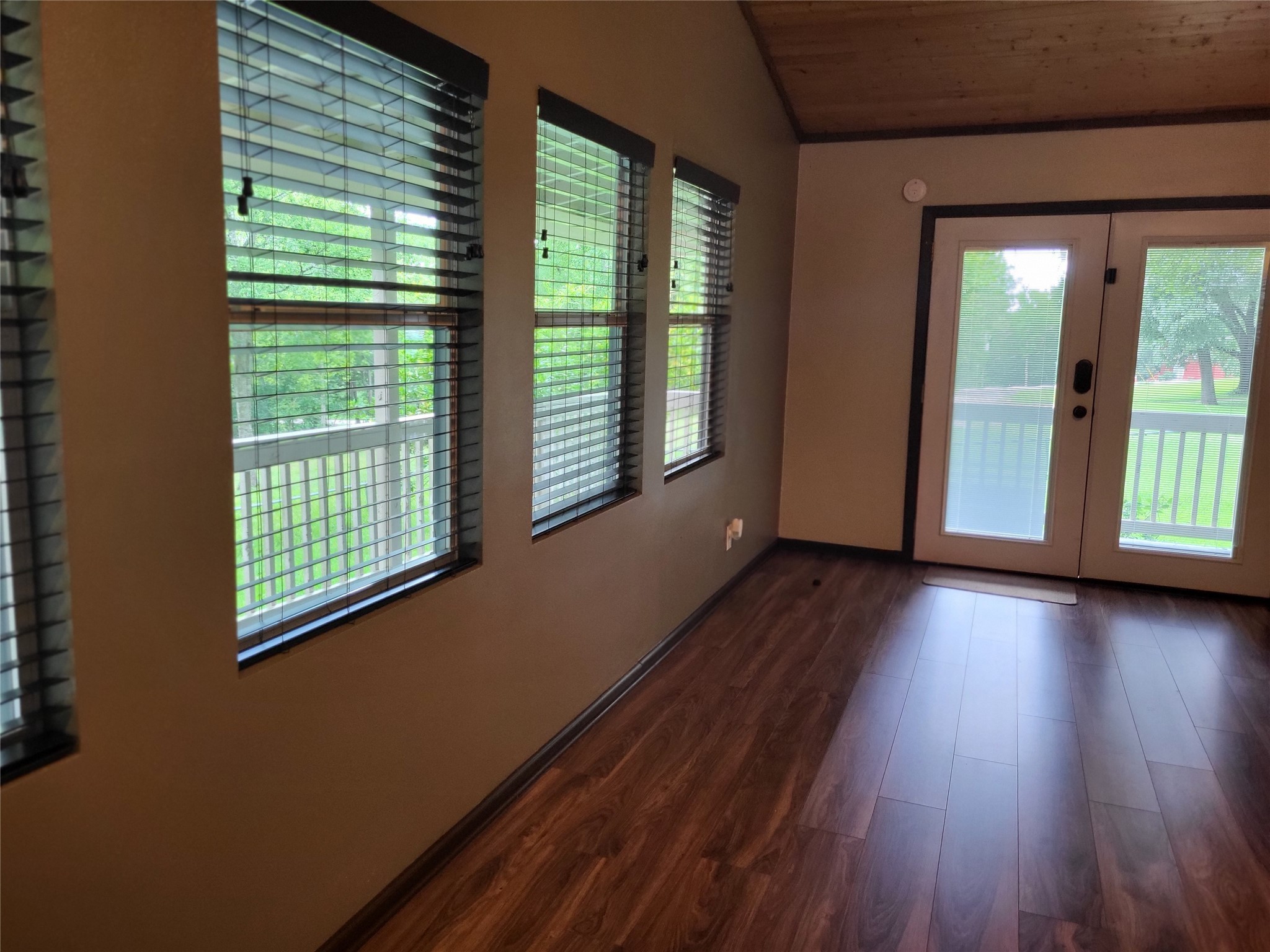 30 Ridge Creek Drive Coldspring, TX 77331 - Photo 8 of 38 a view of an empty room with wooden floor and a window