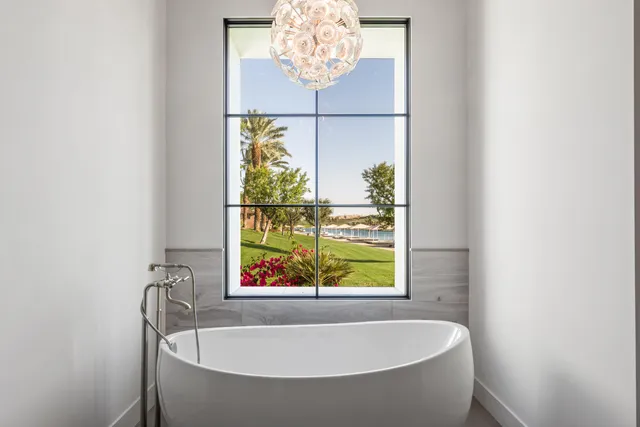 a bedroom with a bed and large window