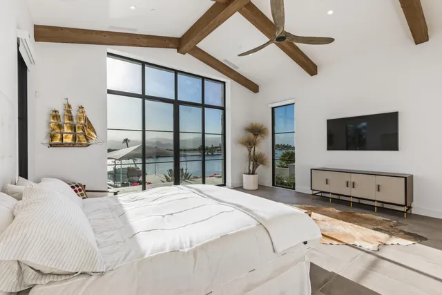 a bedroom with a large bed and a window