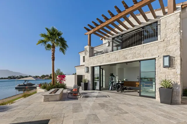 a view of swimming pool with outdoor seating and lake view