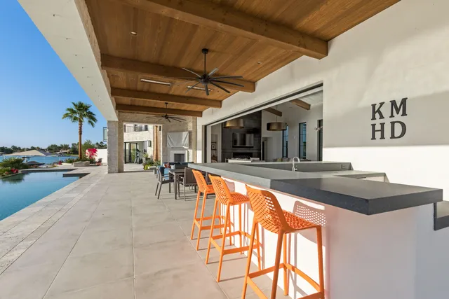 an aerial view of a house with a garden and lake view