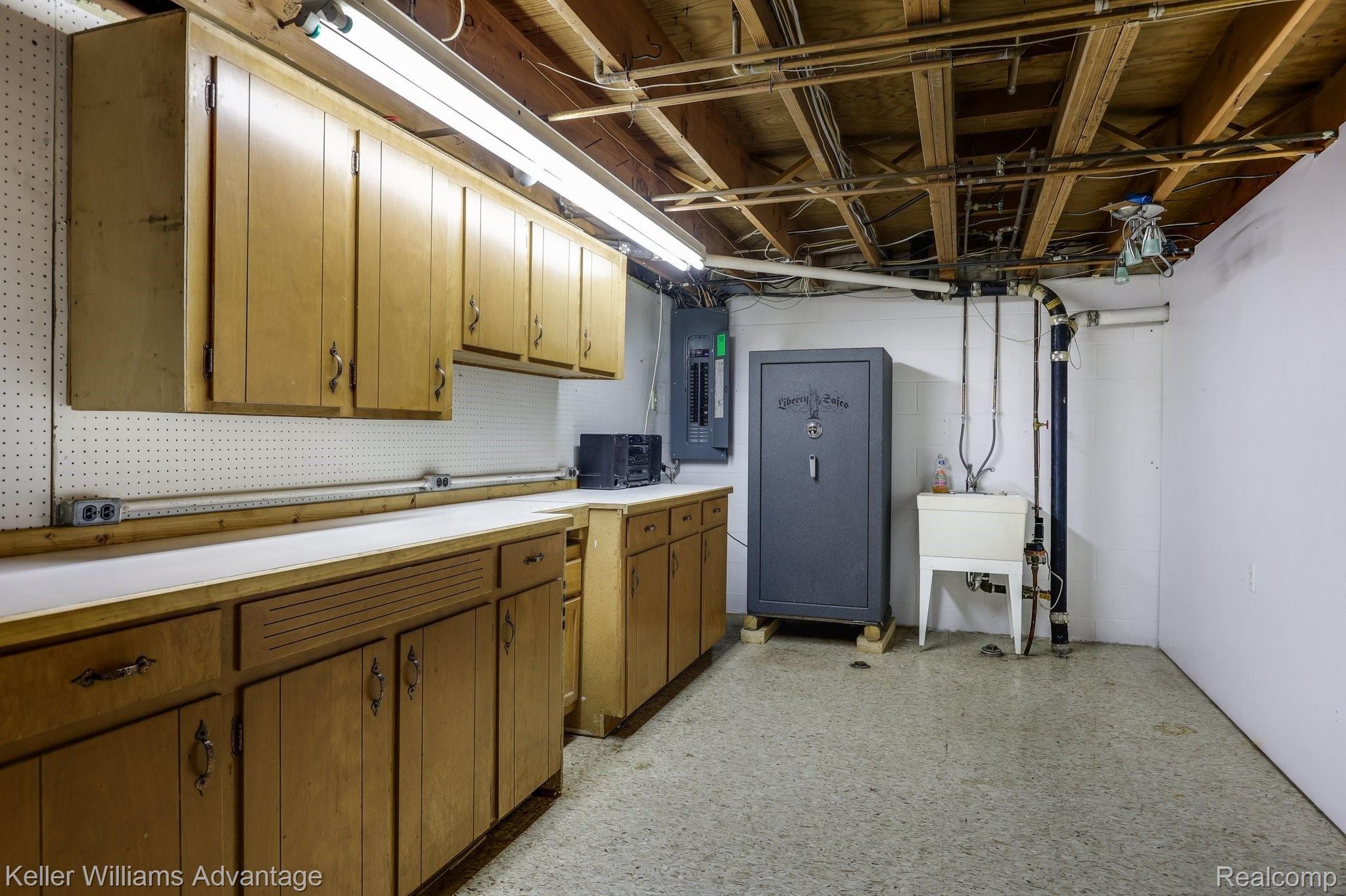 29260 Olmstead Road Flat Rock, MI 48134 - Photo 17 of 30 Basement workshop with built in cabinetry and utility sink