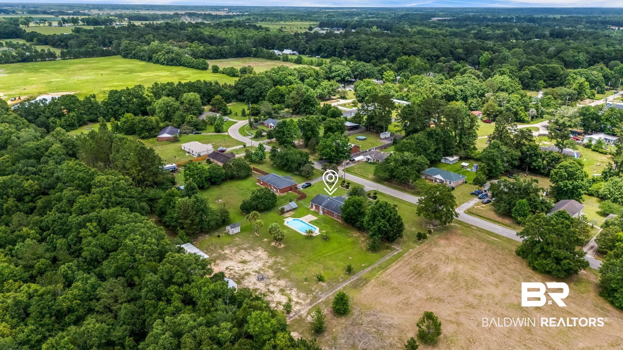 15096 Highland Circle Foley, AL 36535 - Photo 35 of 52 Aerial perspective showcasing a residential area amidst expansive green landscapes
