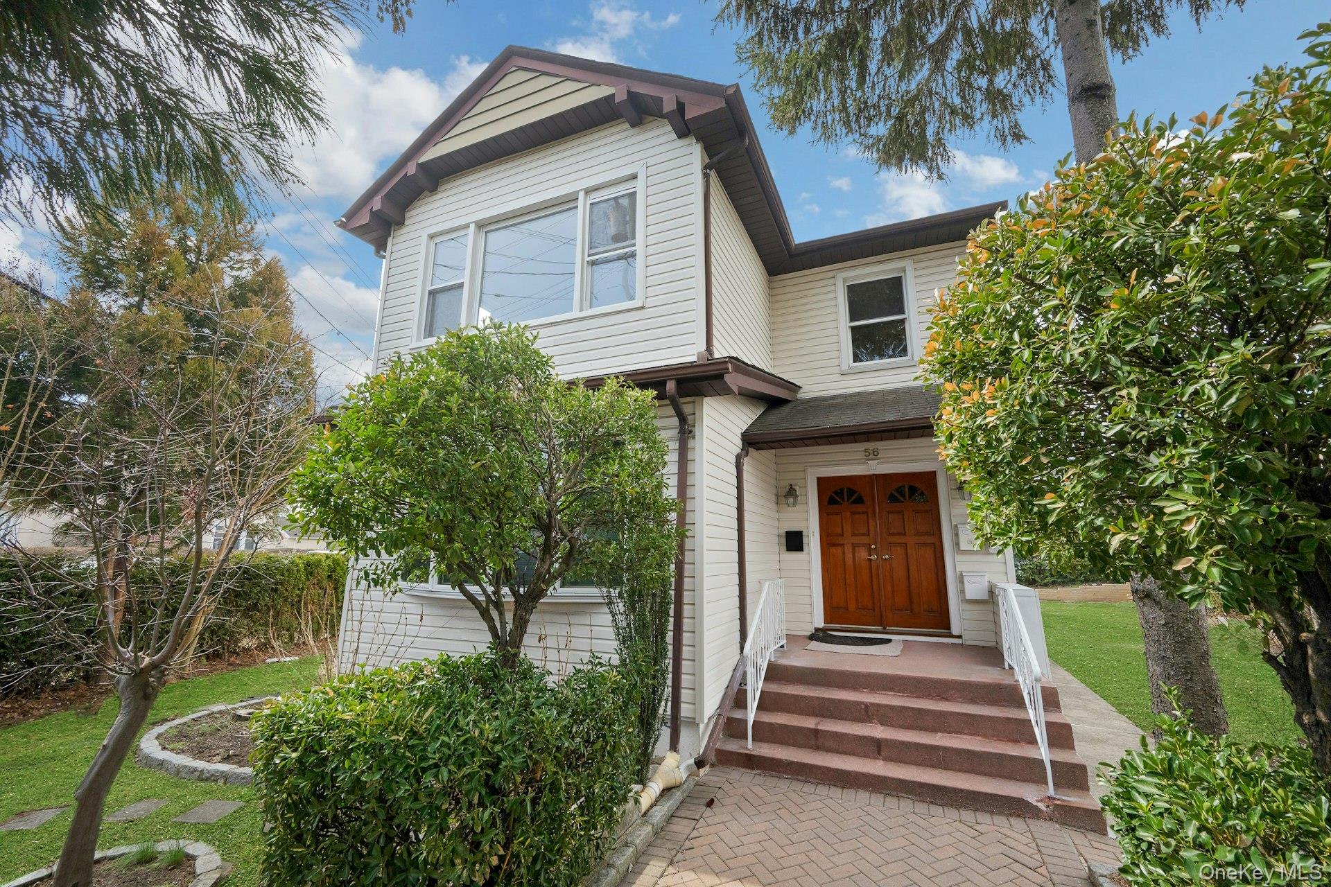 a house that has a tree in front of the house