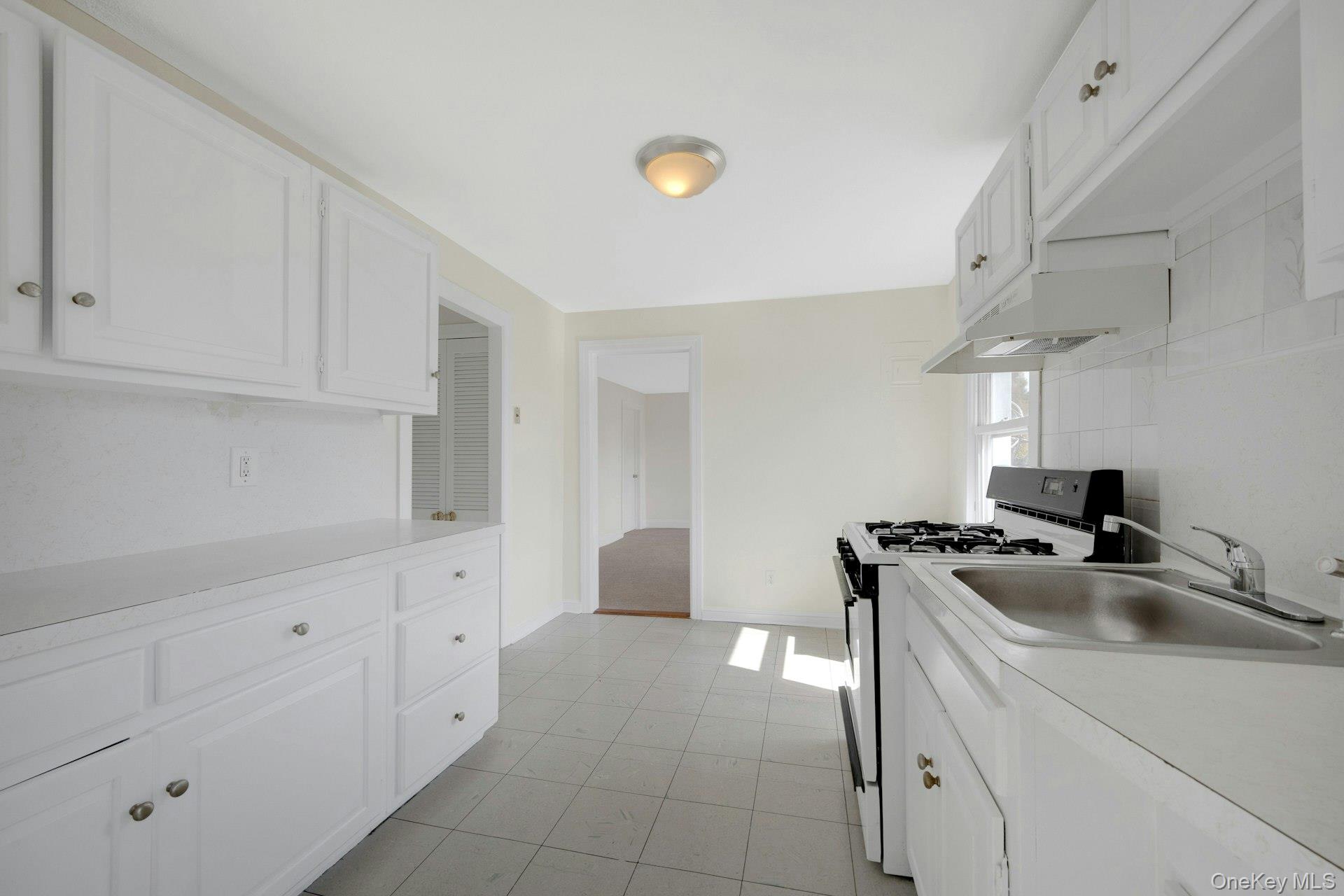 56 Stephenson Boulevard New Rochelle, NY 10801 - Photo 17 of 44 a room with cabinets and a stove top oven