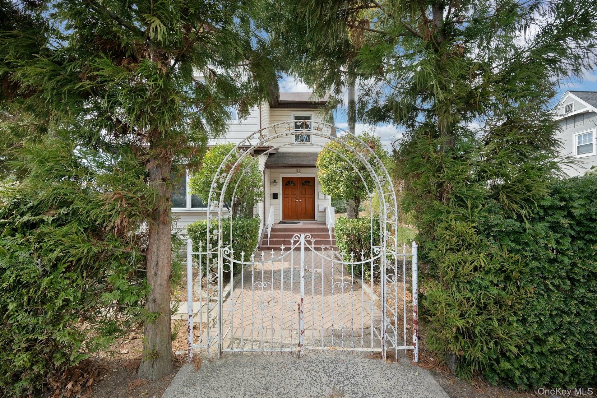 56 Stephenson Boulevard New Rochelle, NY 10801 - Photo 2 of 44 front view of a house with a garden