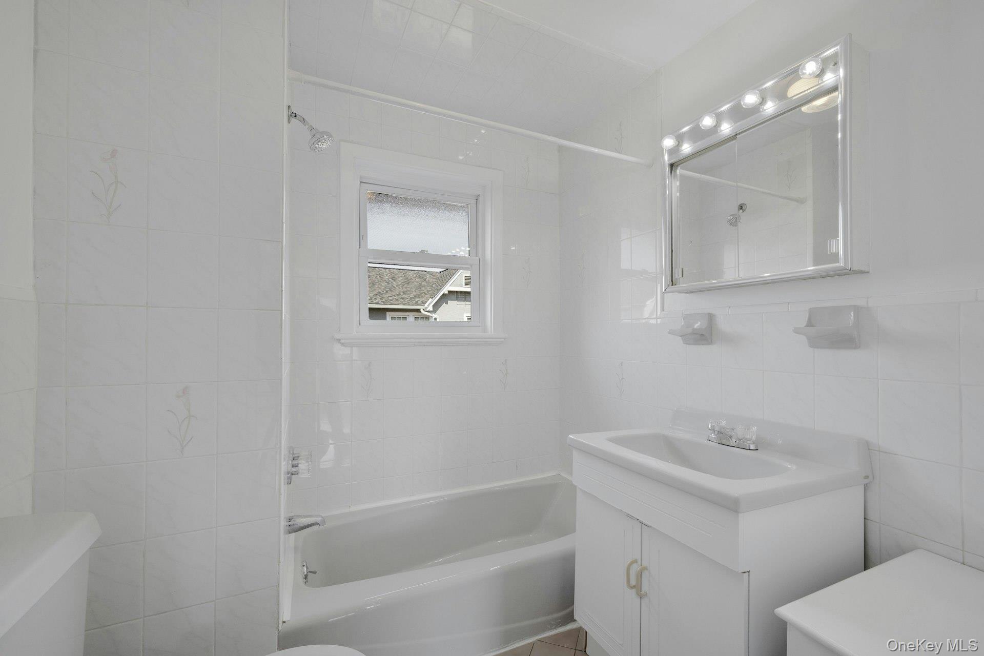 56 Stephenson Boulevard New Rochelle, NY 10801 - Photo 22 of 44 a bathroom with a sink a toilet and shower
