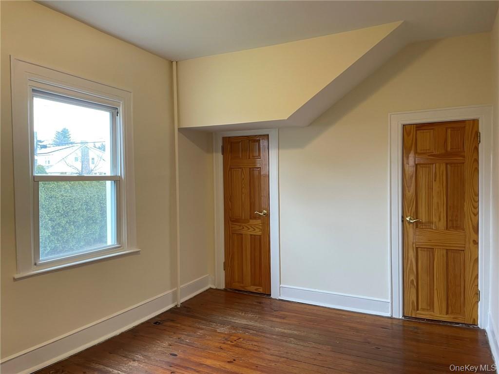 56 Stephenson Boulevard New Rochelle, NY 10801 - Photo 28 of 44 a view of an empty room with wooden floor and a window