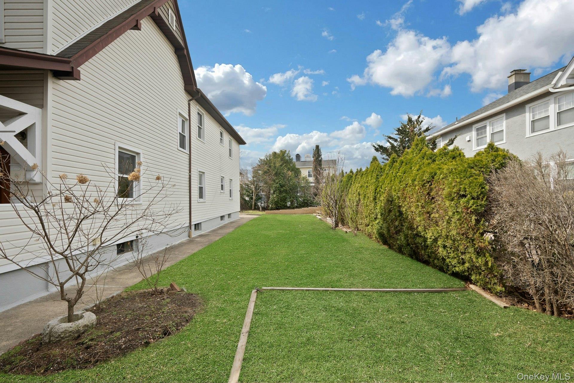 56 Stephenson Boulevard New Rochelle, NY 10801 - Photo 37 of 44 a backyard of a house with lots of green space