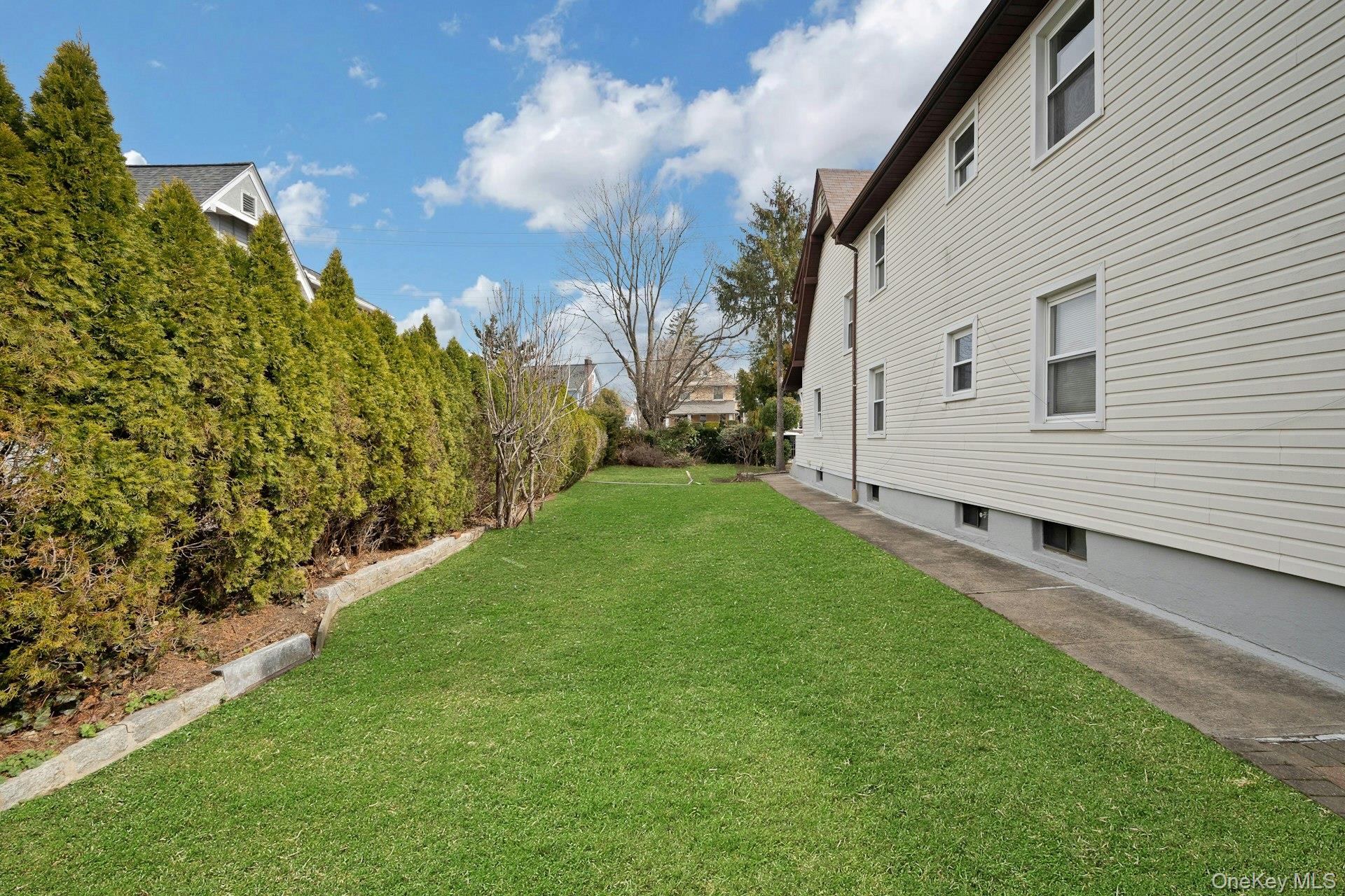 56 Stephenson Boulevard New Rochelle, NY 10801 - Photo 40 of 44 a view of a backyard with plants and large trees