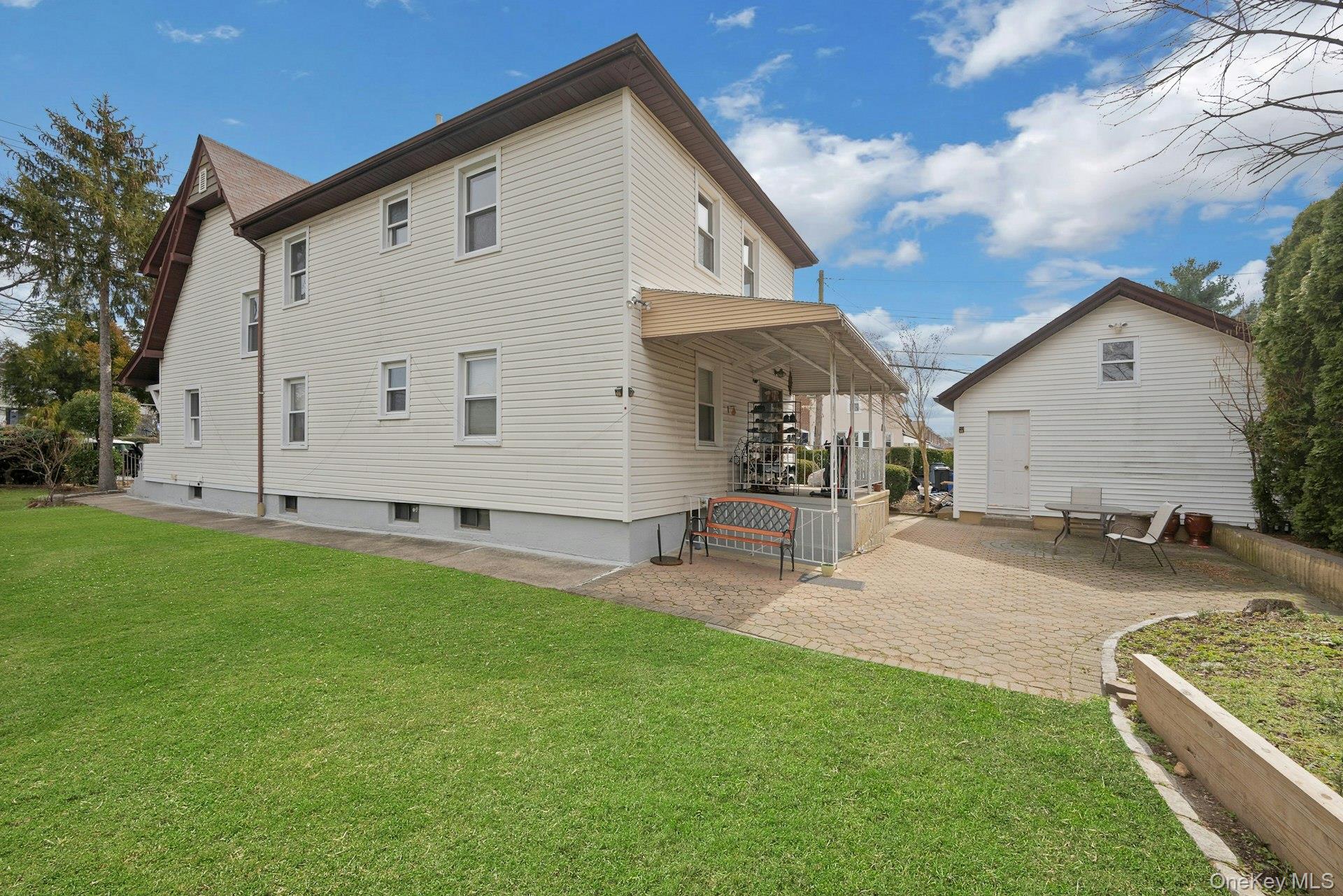 56 Stephenson Boulevard New Rochelle, NY 10801 - Photo 41 of 44 a view of a backyard with chairs and a fire pit