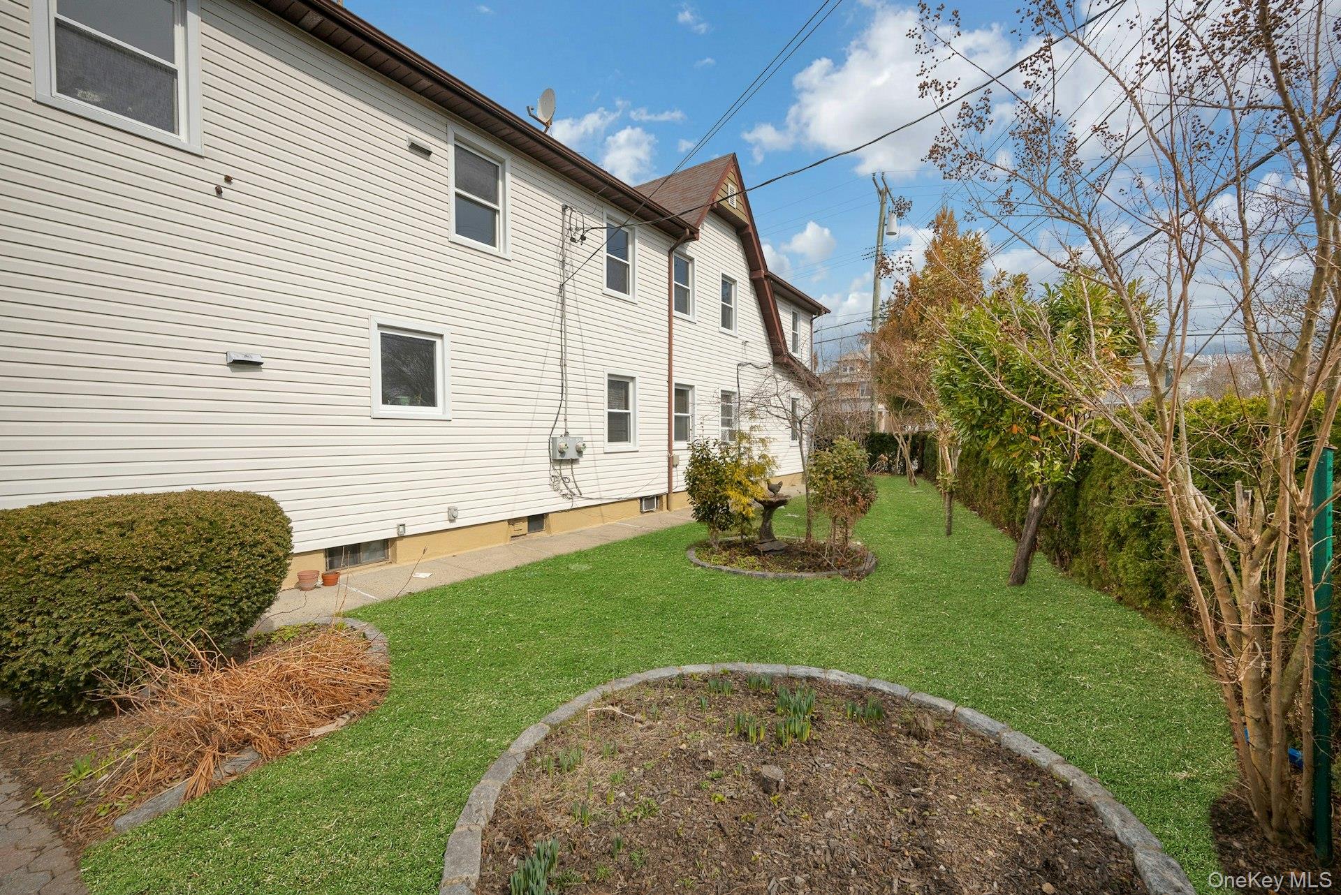 56 Stephenson Boulevard New Rochelle, NY 10801 - Photo 42 of 44 a view of a white house with a yard