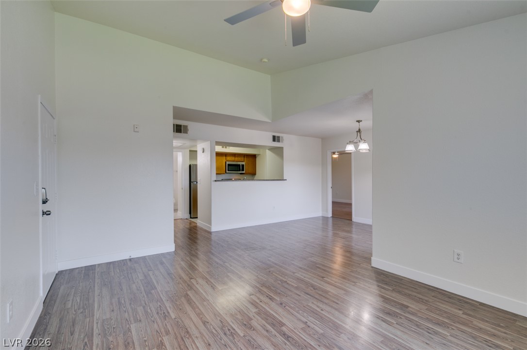 6650 West Warm Springs Road, Unit 2118 Las Vegas, NV 89118 - Photo 41 of 41 An open floorplan seamlessly connects the living area, kitchen, and dining space, all highlighted by lustrous wood flooring.