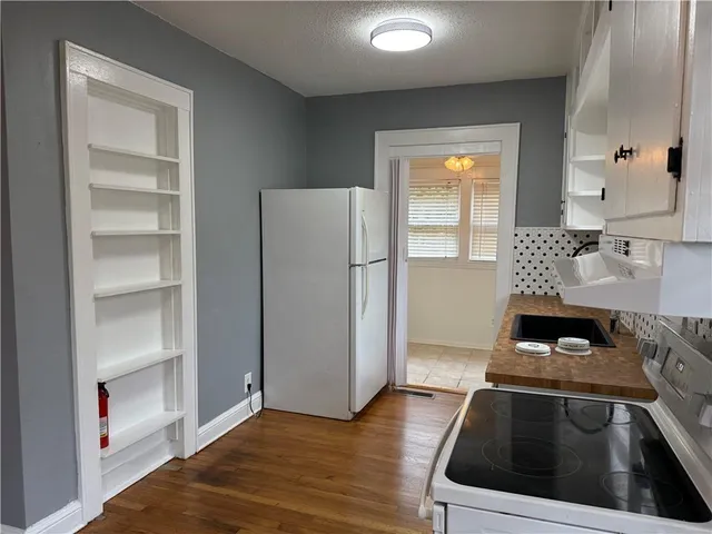 a kitchen with a refrigerator and a stove