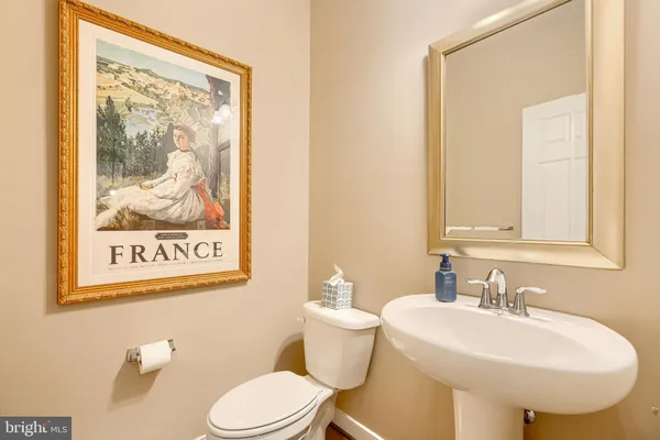 a living room with furniture a rug and a lamp