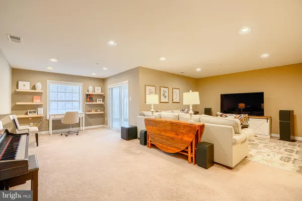 a view of a workspace with furniture and a window