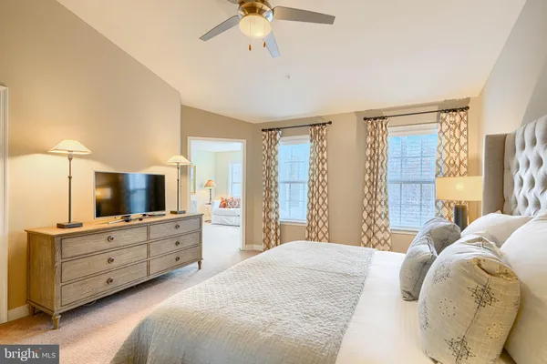 a bedroom with a large bed and a chandelier