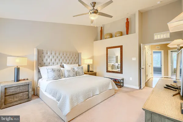 a bedroom with a large bed and a chandelier