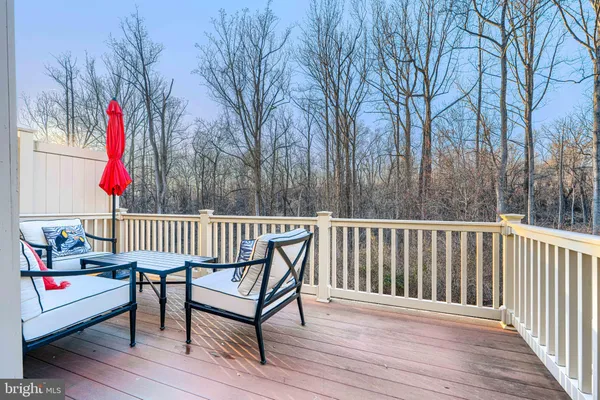 a view of a patio with a table and chairs and wooden floor
