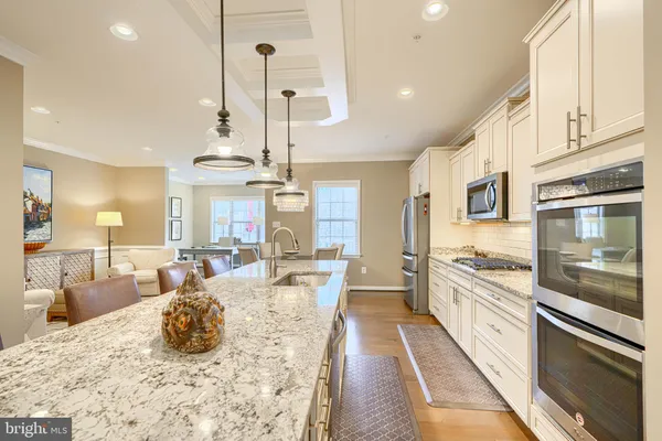 a large kitchen with kitchen island granite countertop a large counter top appliances and cabinets