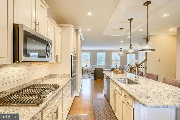 a kitchen with counter top space appliances and wooden floor