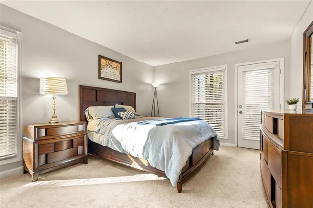 a bed room with a bed and a refrigerator