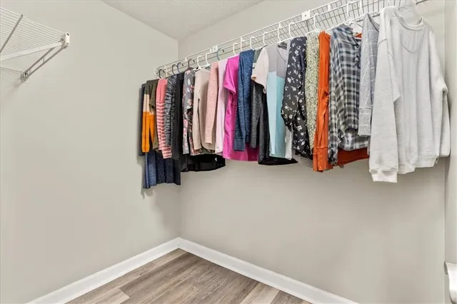 a view of walk in closet with clothes