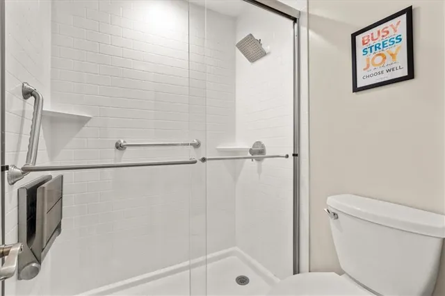 a bathroom with a shower and a toilet