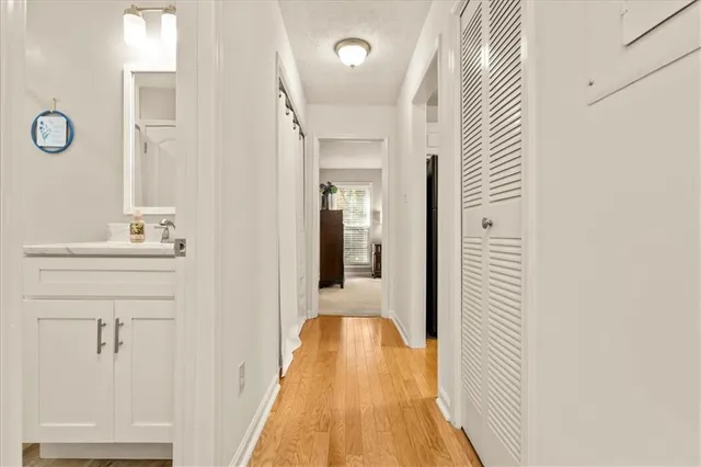 a view of a hallway with wooden floor and staircase