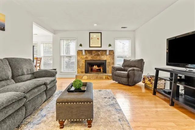 a living room with furniture and a fireplace