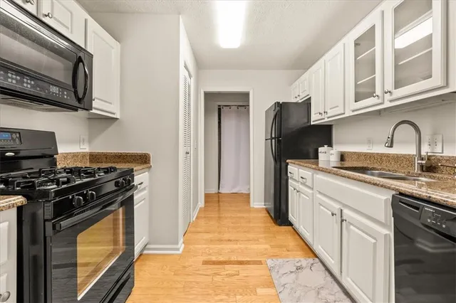 a kitchen with stainless steel appliances granite countertop a stove and a sink