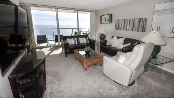 a living room with furniture and a floor to ceiling window