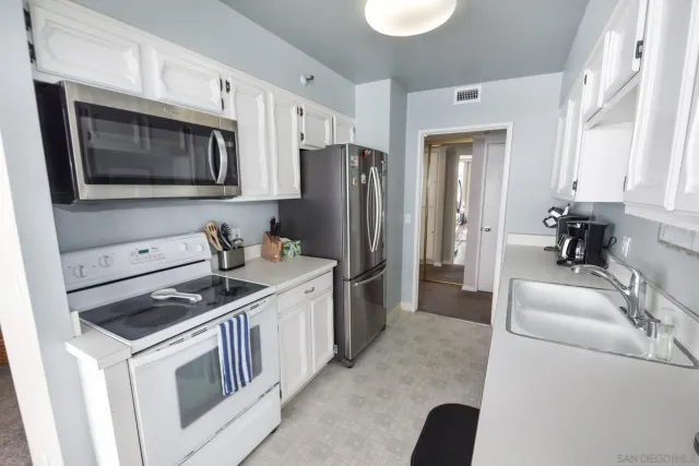 a kitchen with stainless steel appliances granite countertop a stove microwave and refrigerator