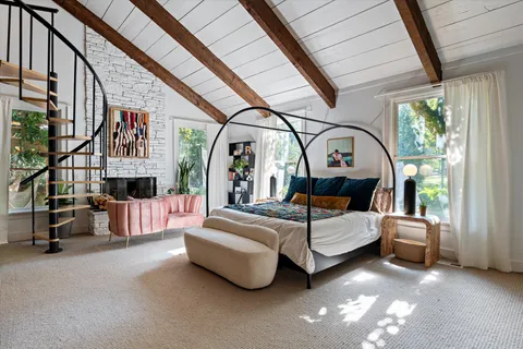 a bedroom with a bed and a window