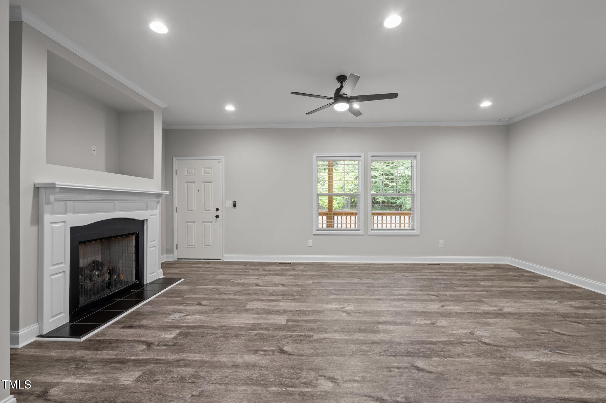 221 Country Lane Timberlake, NC 27583 - Photo 11 of 39 a view of an empty room with a fireplace and a window