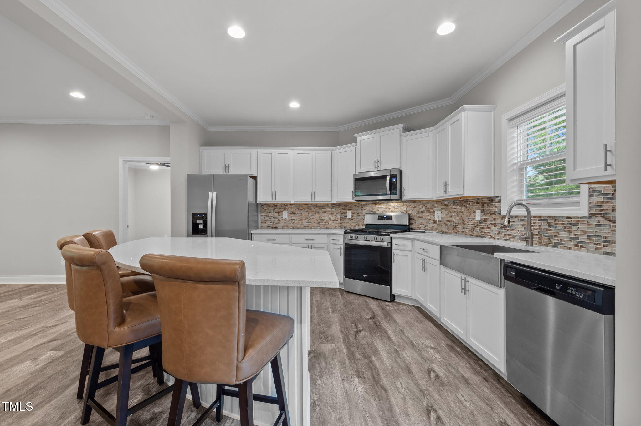 221 Country Lane Timberlake, NC 27583 - Photo 14 of 39 a kitchen with stainless steel appliances granite countertop a white cabinets and wooden floor