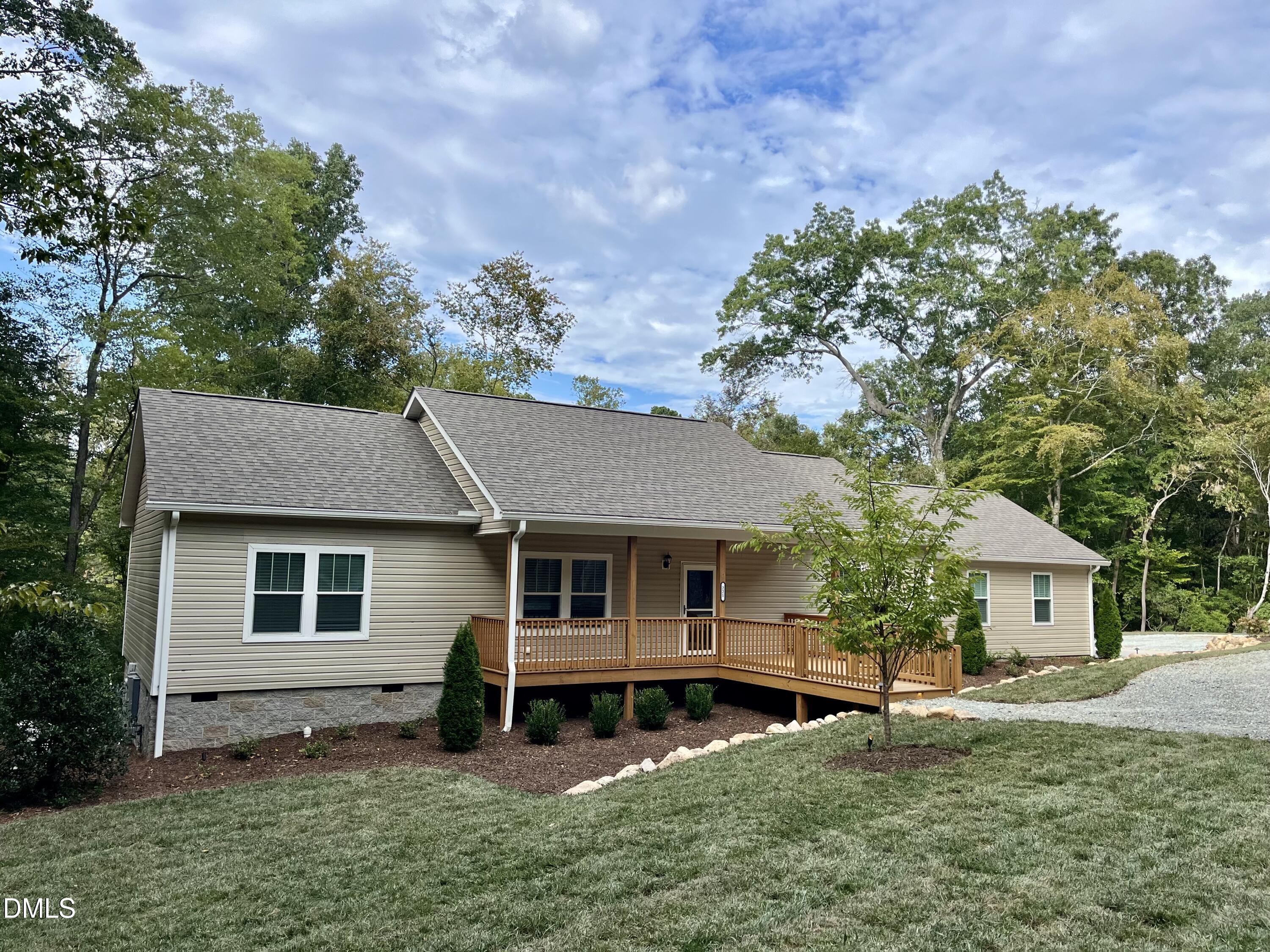 221 Country Lane Timberlake, NC 27583 - Photo 4 of 39 a front view of a house with garden