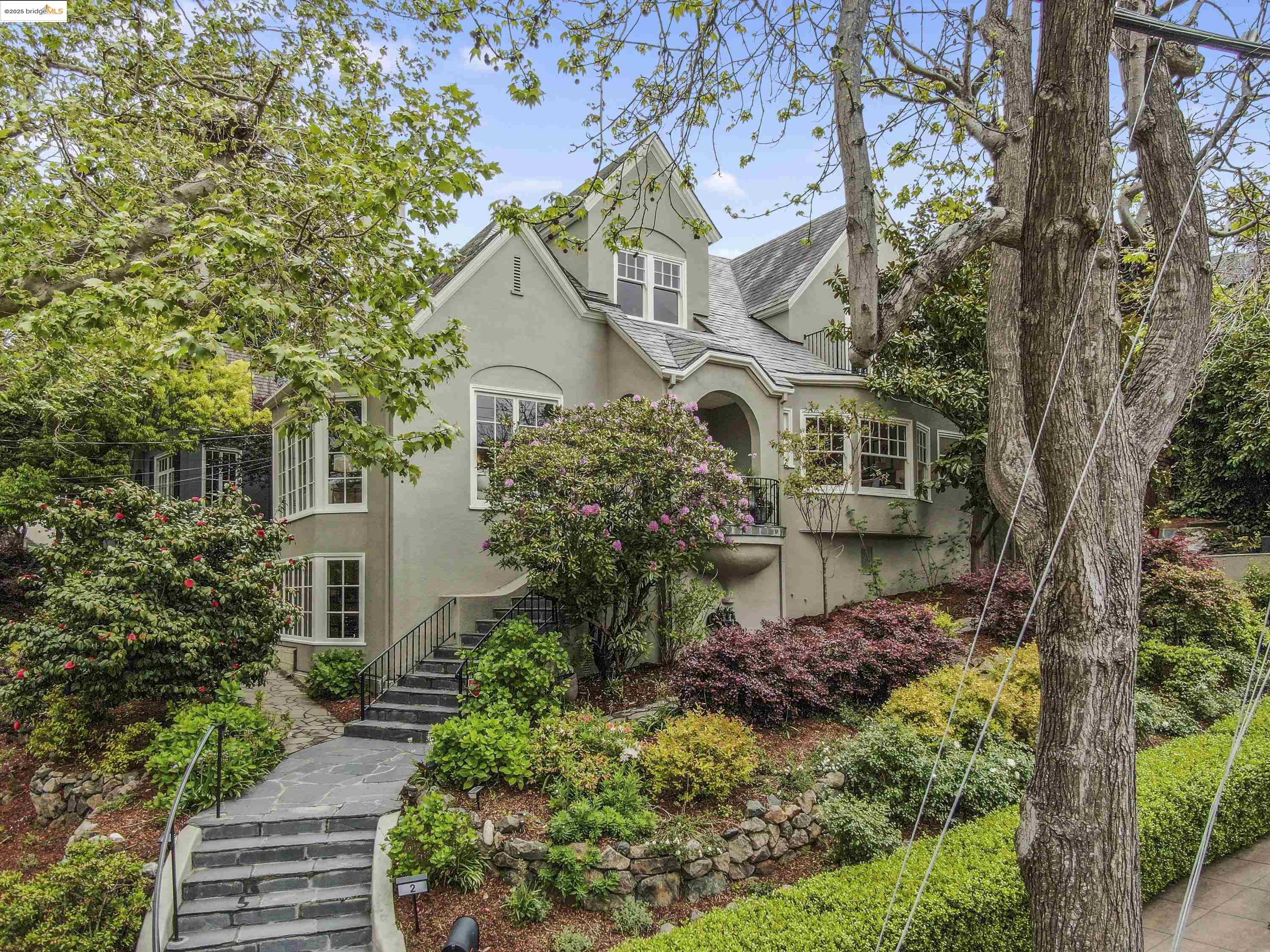 a front view of a house with a garden
