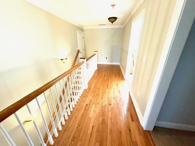 4310 Enoch Road Aynor, SC 29511 - Photo 21 of 39 Hall with ornamental molding, light wood-style flooring, and an upstairs landing