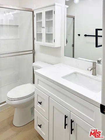 a view of a kitchen with wooden floor and electronic appliances