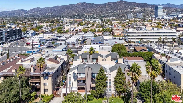 an aerial view of residential building and trees