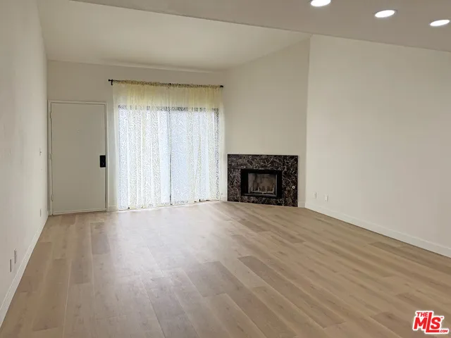 a kitchen with white cabinets and white stove
