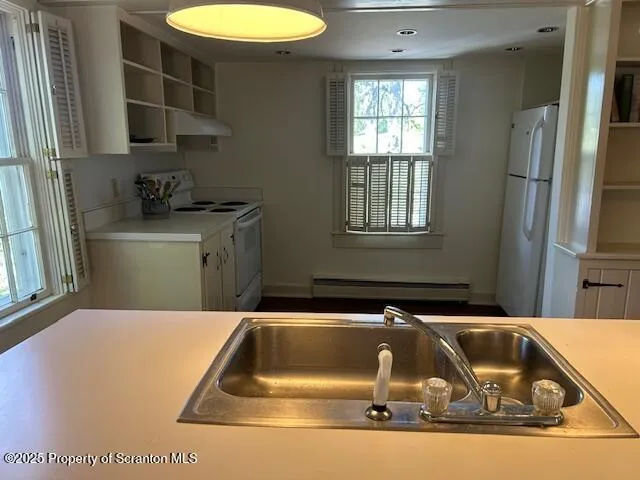 a kitchen with a sink and a refrigerator