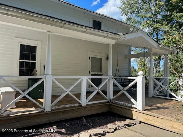 a front view of a house with plants