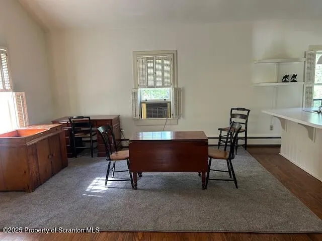a view of a workspace with furniture and window