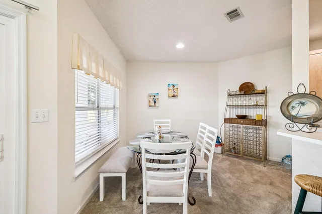 a dining room with furniture and window