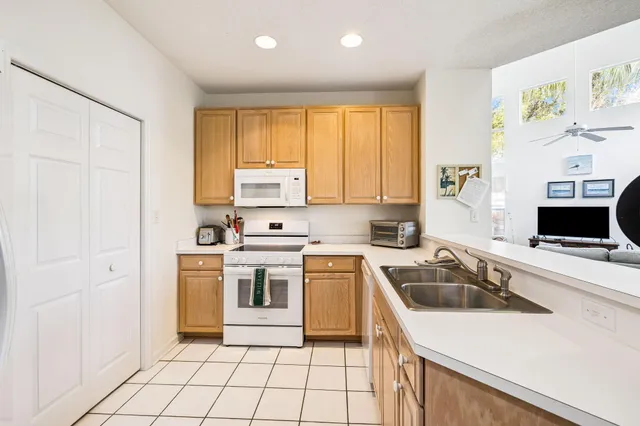 a kitchen with a sink cabinets and window