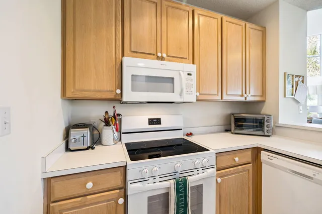 a kitchen with granite countertop cabinets stainless steel appliances and a sink
